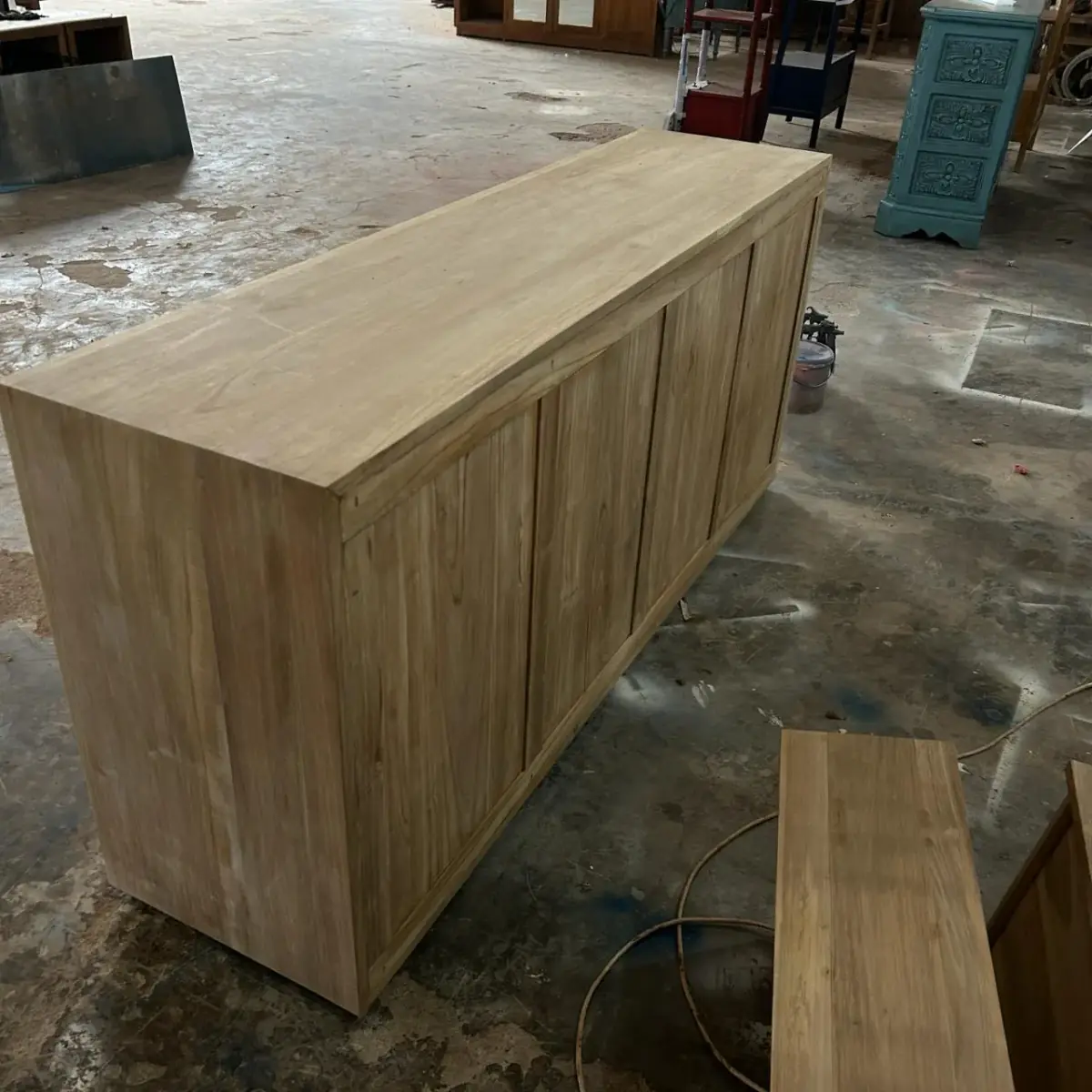 Oka 9-drawer teak console, front angle showing hand-fitted drawers